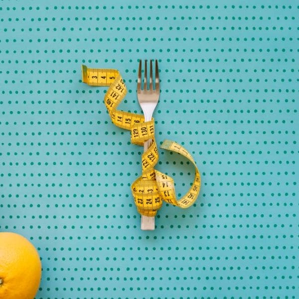 Healthy eating concept with oranges and measuring tape.