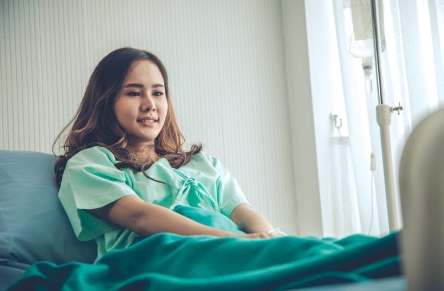 Female patient resting in hospital bed